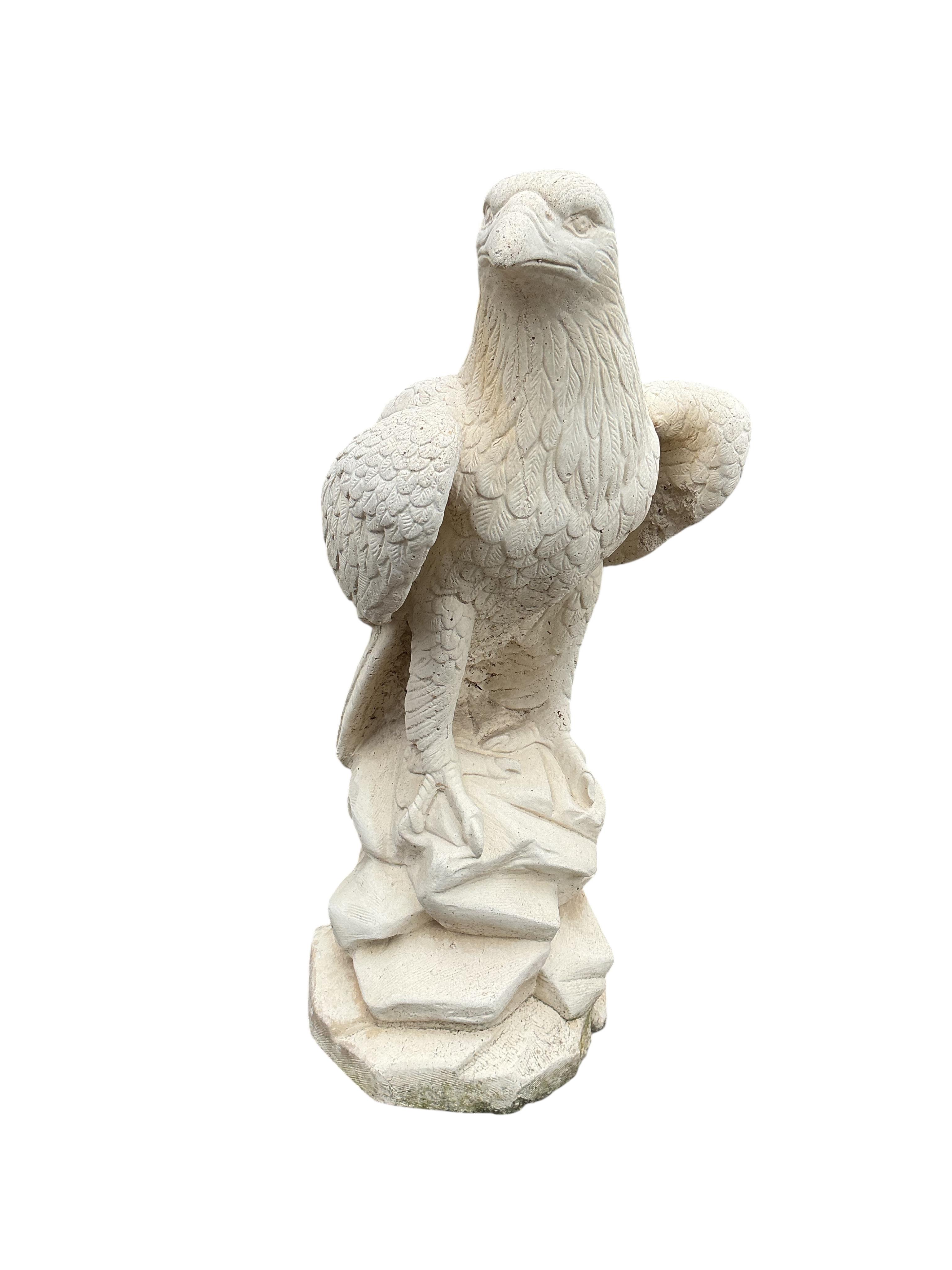 A pair of reconstituted stone eagle garden ornaments, height 60cm